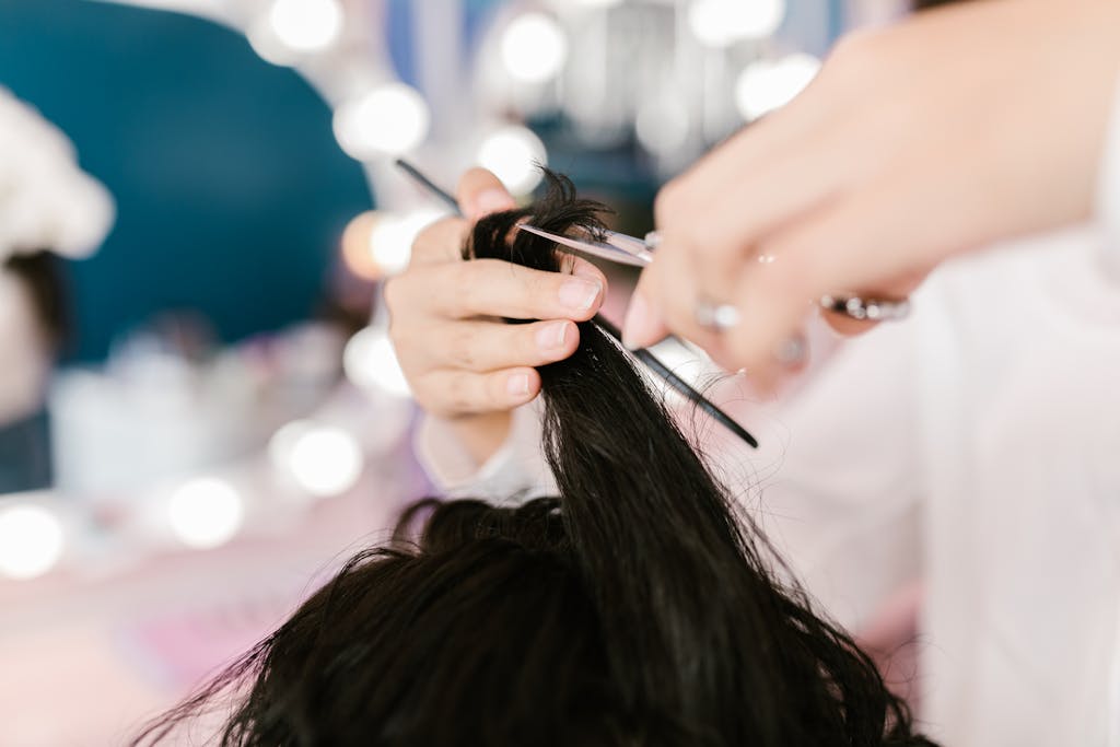 Close-up of a stylist cutting hair in a contemporary salon setting.